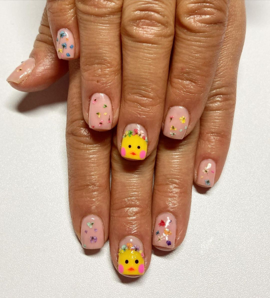 Easter nails beige polish with chicks and scattered flowers